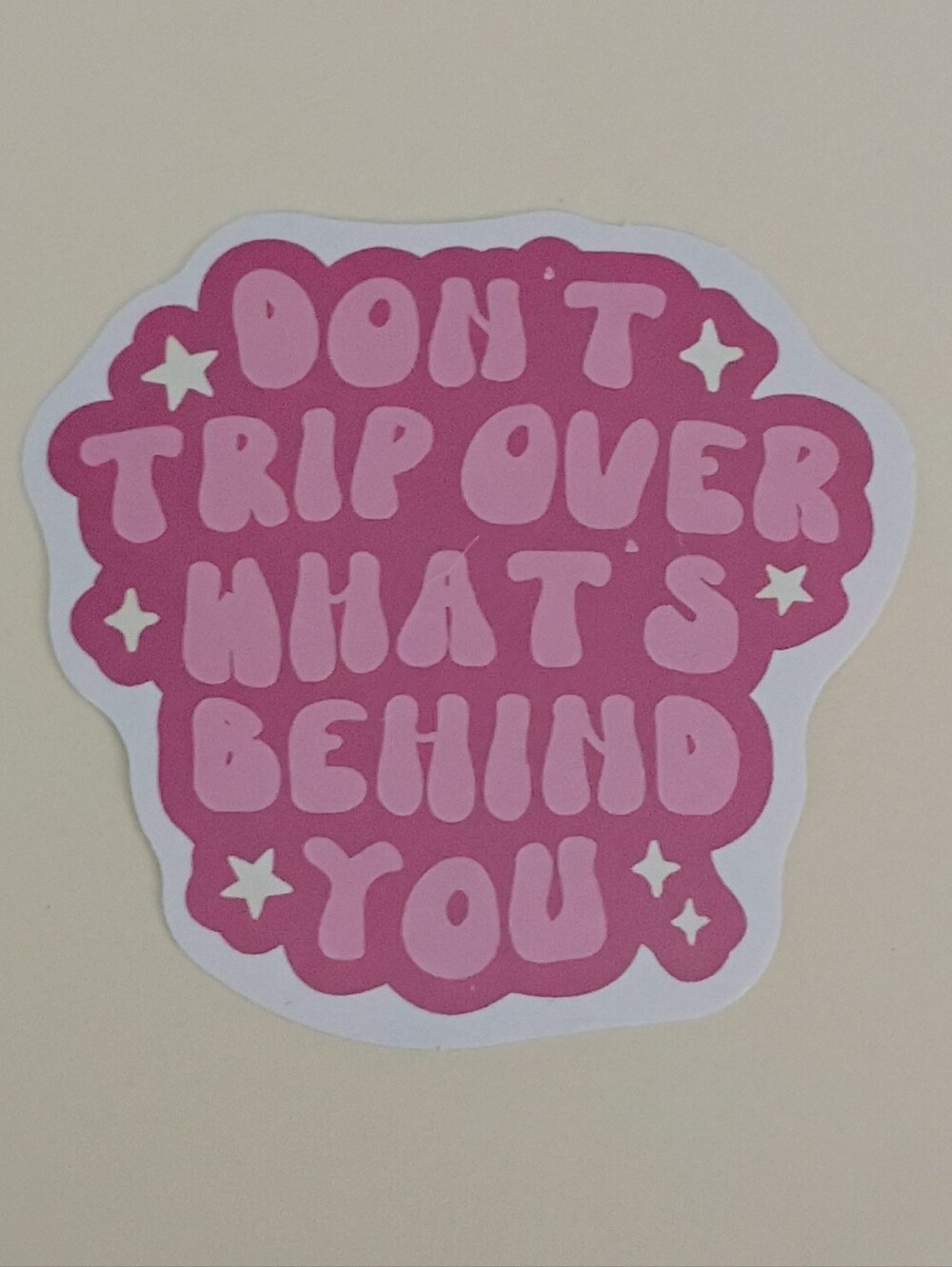 10/$10 Sticker - Don't Trip Over What's Behind You - Pink Text, White Sparkles
